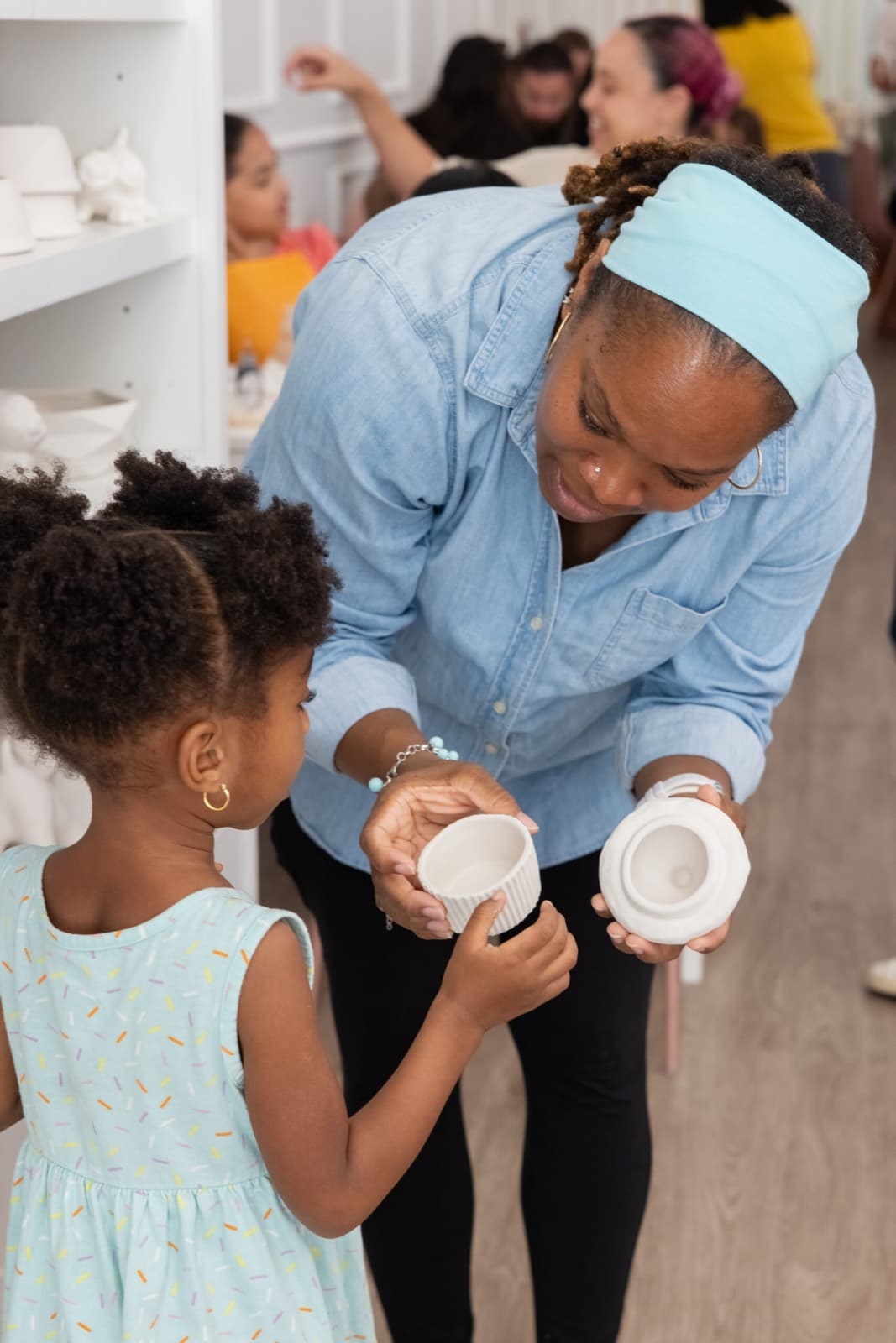 Customers choosing pottery to paint at the studio